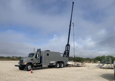 A large truck equipped with a crane on its top, showcasing its heavy-duty capabilities for lifting and transporting materials.